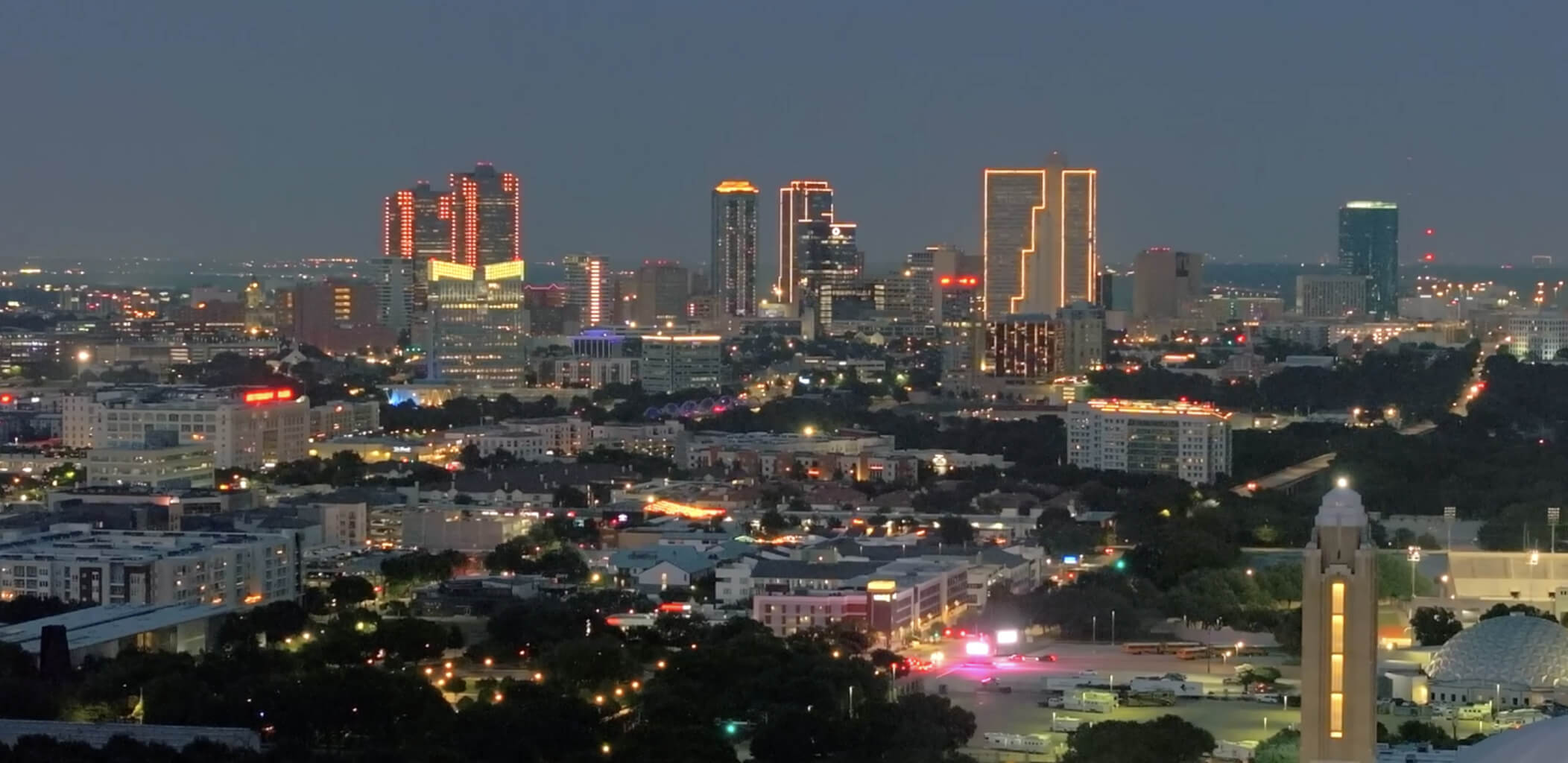 Aerial view of downtown Fort Worth illuminated at night with city lights.