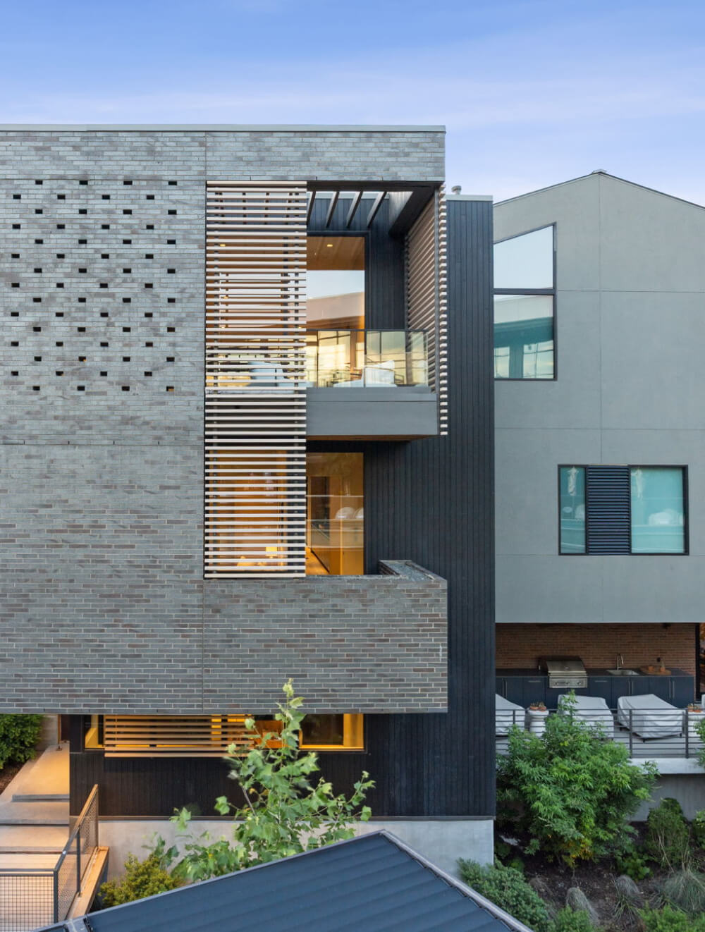Exterior of Unit 6 highlighting architectural detailing around the windows and private deck.